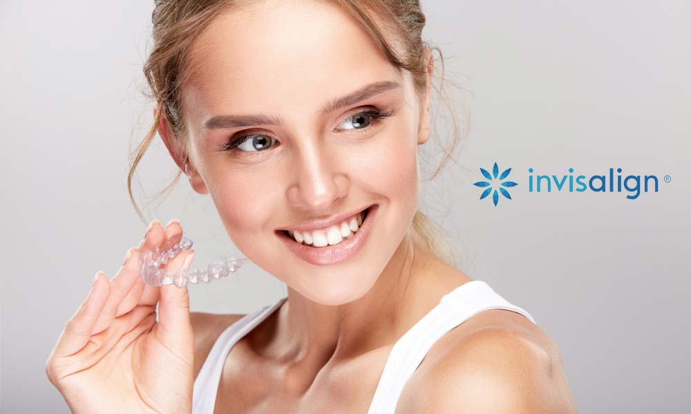 Girl Holding an Invisalign Tray